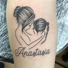 a woman holding a baby in her arms with the word anatassia on it