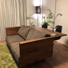 a couch sitting on top of a wooden floor next to a table