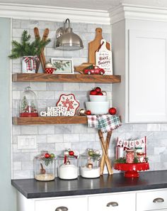 the kitchen counter is decorated with christmas decorations and holiday decor on it's shelves