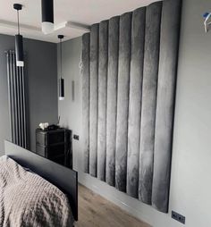 a bed room with a neatly made bed next to a wall mounted radiator