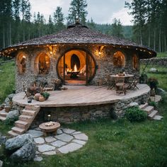 a small stone building with lights on it