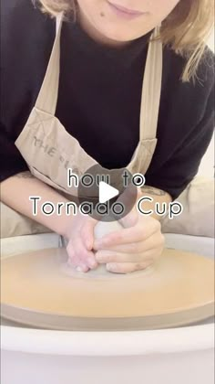 a woman is making something out of clay with her hands on top of the pottery