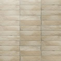 a wall made out of beige tiles with no one in the photo or description on it