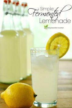 a lemonade drink in a glass next to two lemons