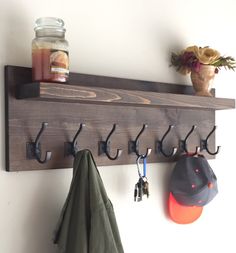 there is a coat rack with hooks on it and hats hanging from the hooks