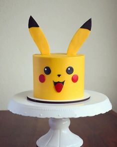 a yellow cake with pikachu ears on it