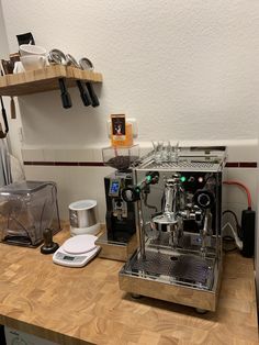 a coffee machine sitting on top of a wooden counter