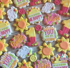 decorated cookies are arranged on a table with the words you are happy in different colors