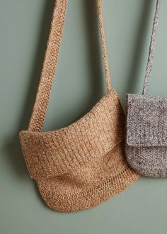 two purses hanging on the wall, one is made out of knitted material