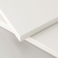 two pieces of white paper on top of each other