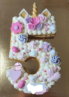 a cake shaped like the number five with decorations on it