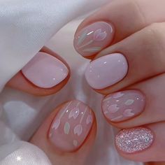 a woman's hands with pink and white manies