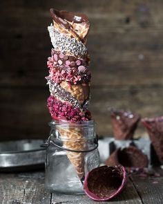 a stack of chocolate covered donuts in a jar