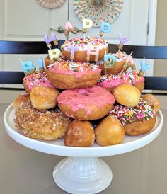 a birthday cake made out of doughnuts and sprinkles