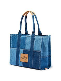 a blue denim bag with leather handles