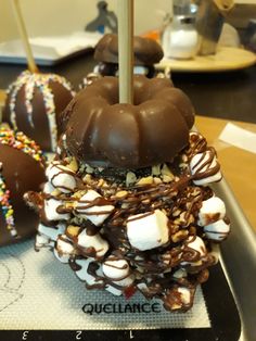 chocolate covered donuts stacked on top of each other