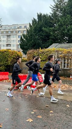 a group of people running in the rain