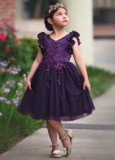 Fit for a princess, this dress has it all. Soft eggplant purple satin graced with a touch of lace, this dress is a showstopper! Sleeves are embellished with whimsical die cut flowers that will have all eyes on her. Tuling overlay skirt adds just the right touch of fullness and twirl. Fully lined with soft cotton, back zip. 100% poly self, 100% cotton lining. Machine wash, hang dry. Purple Toddler Dress, Purple Flower Girls, Purple Flower Girl Dress, Dark Purple Dresses, Purple Girls Dress, Dark Purple Flowers, Bianca Dress, Dress Infant, Overlay Skirt