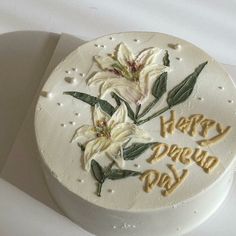 a white cake decorated with flowers and the words happy new year on it's side