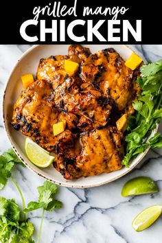 grilled chicken with mango and cilantro garnish on a white plate