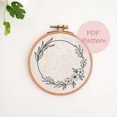 a hand embroidered hoop with an image of a flower on it and the words pdf pattern above it