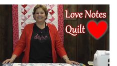 a woman standing in front of a quilt with the words love notes quilt