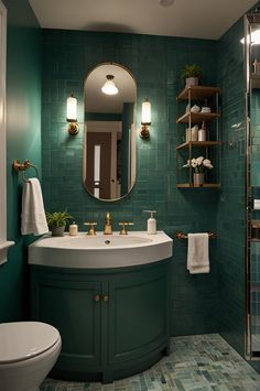 a bathroom with green tile and gold fixtures on the wall, along with a white toilet