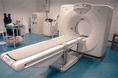 an mri machine is shown in the middle of a room with other medical equipment around it