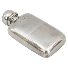 a silver flask with a chain hanging from it