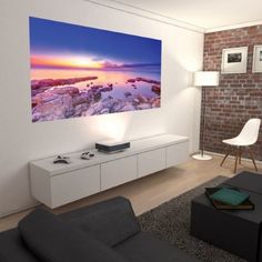 a living room filled with furniture and a flat screen tv mounted to the side of a wall