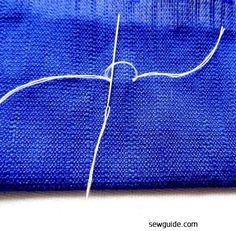 a blue piece of cloth with white thread