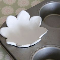 a muffin tin with a paper flower on it