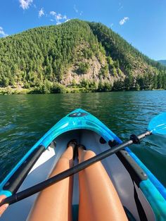 a person is sitting in a kayak on the water