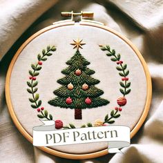 a cross stitch christmas tree in a wreath with the words pdf pattern on it