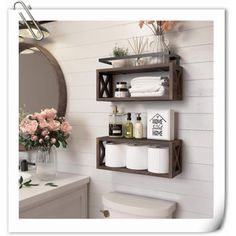 a bathroom with three shelves holding toilet paper and other items on the wall next to a sink