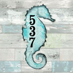 a sea horse on a wooden wall with the number 537 in it's tail