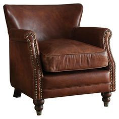 a brown leather chair sitting on top of a wooden floor