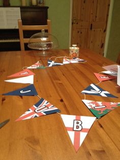 a wooden table topped with bunting flags on top of it