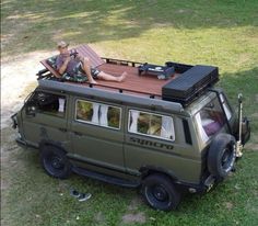 a man sitting on top of a vehicle with a picnic table attached to the roof