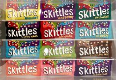 six skittles are stacked on top of each other in a clear box with the words skittles written below them