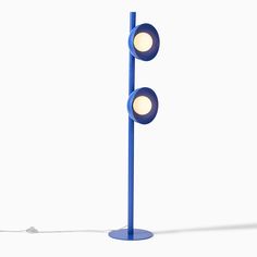 a blue floor lamp with two lights on it