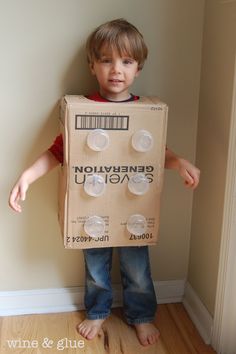 a young boy wearing a cardboard box costume