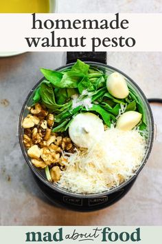 an overhead view of a salad in a blender with the words homemade walnut pesto