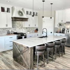 a large kitchen island with stools in it