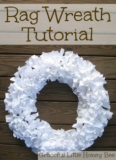 a wreath made out of white tissue paper on top of a wooden background with the words rag wreath