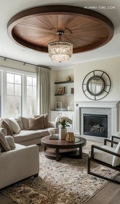 a living room filled with furniture and a fire place in front of a large window