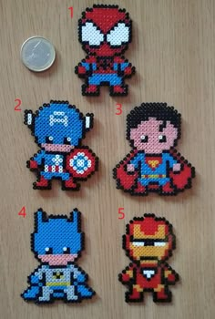 the avengers and spiderman perler bead magnets are shown on a table