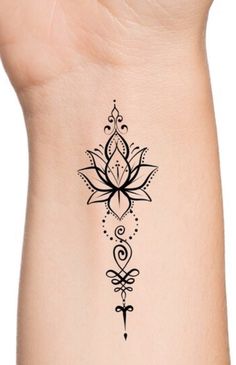 a black and white tattoo design on the side of a woman's arm,