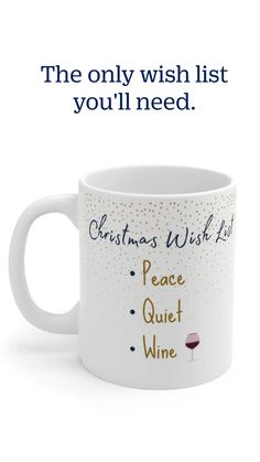 a white coffee mug with the words christmas wish list and a glass of wine on it