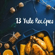 a blue tray filled with roasted corn and oranges next to pine cones, cinnamon sticks, and other holiday decorations